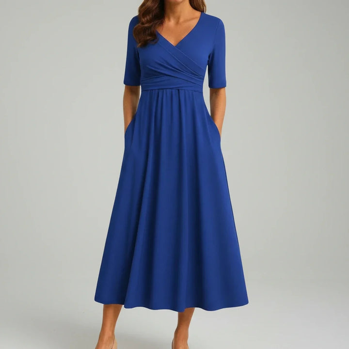 Stylish women's A-line midi dress with V-neckline & functional pockets, offering a versatile & flattering look.
