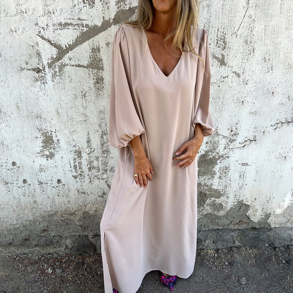 Stylish women's long maxi dress featuring a V-neck, balloon sleeves, and pockets; flowy and comfortable for any occasion.