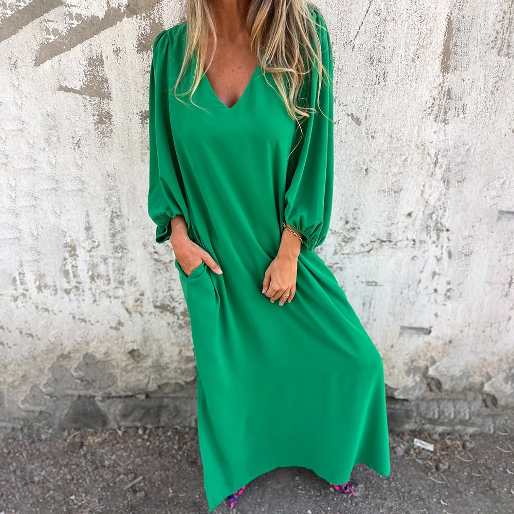 Party-ready elegant flowy maxi dress for women, with a chic V-neck, long skirt, and fashionable balloon sleeves.