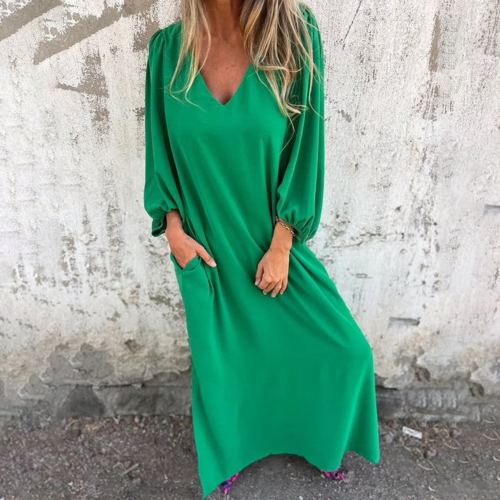 Party-ready elegant flowy maxi dress for women, with a chic V-neck, long skirt, and fashionable balloon sleeves.