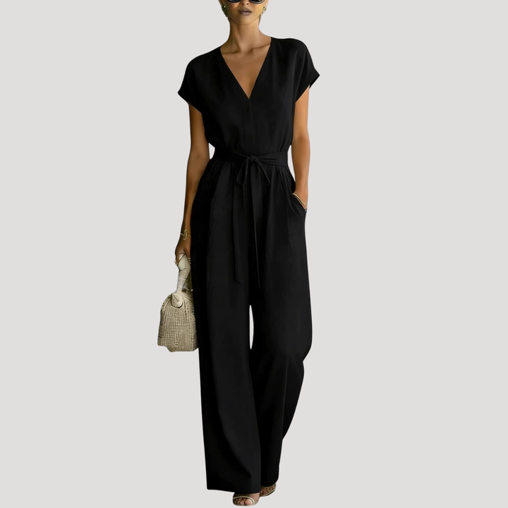 Comfortable women's cap sleeve V-neck jumpsuit. Stylish wide-leg design with an adjustable tie waist for a flattering fit.