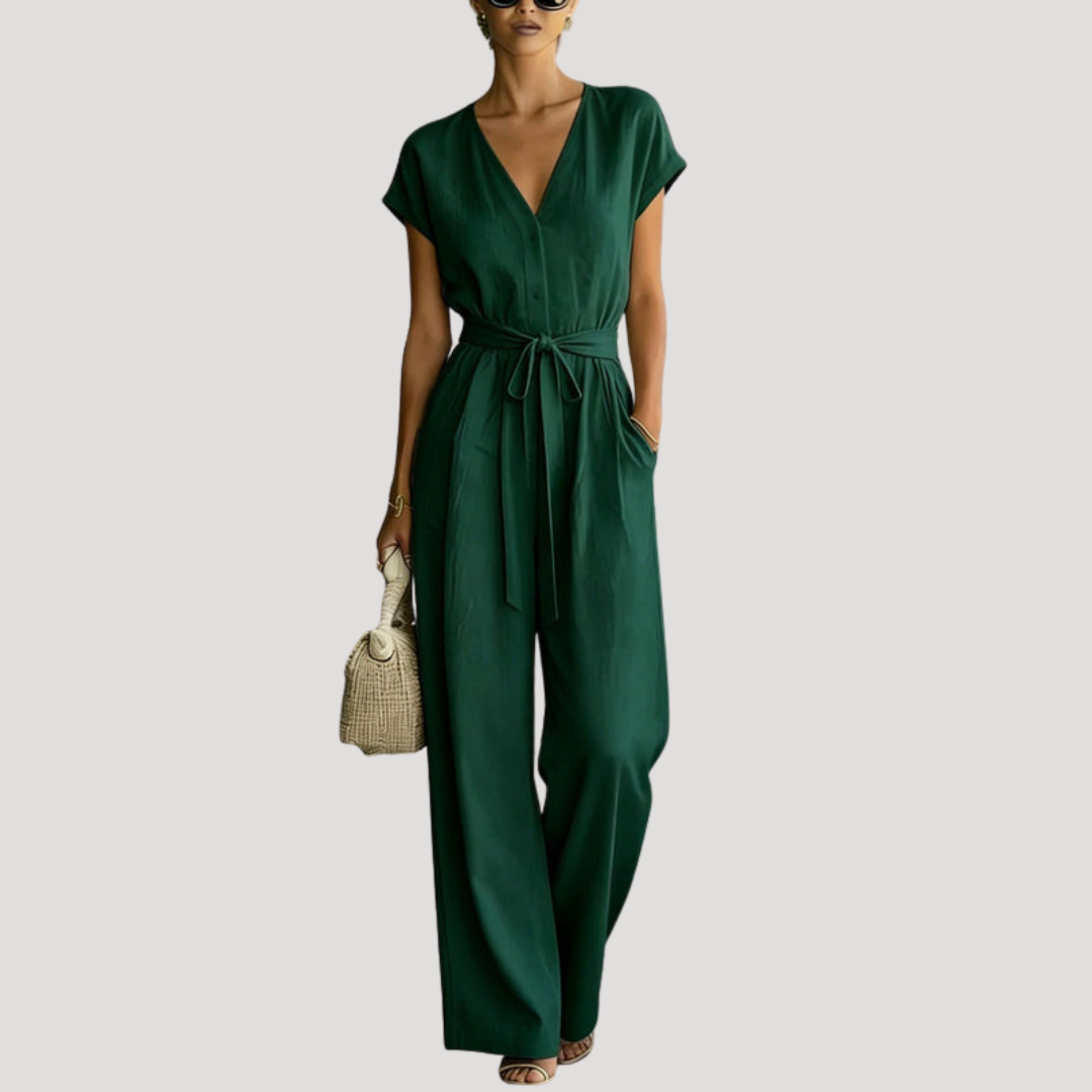 Flattering women's one-piece V-neck jumpsuit. Features cap sleeves, wide legs, and a chic tie waist. Versatile fashion.
