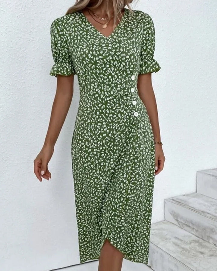 Close-up of vibrant floral print on soft fabric of a women's flowy V-neck summer dress. Spring casual.