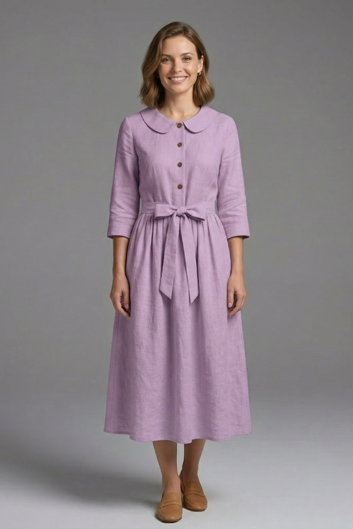 Side view of elegant women's V-neck midi dress with waist tie, showcasing flowy fabric & silhouette.