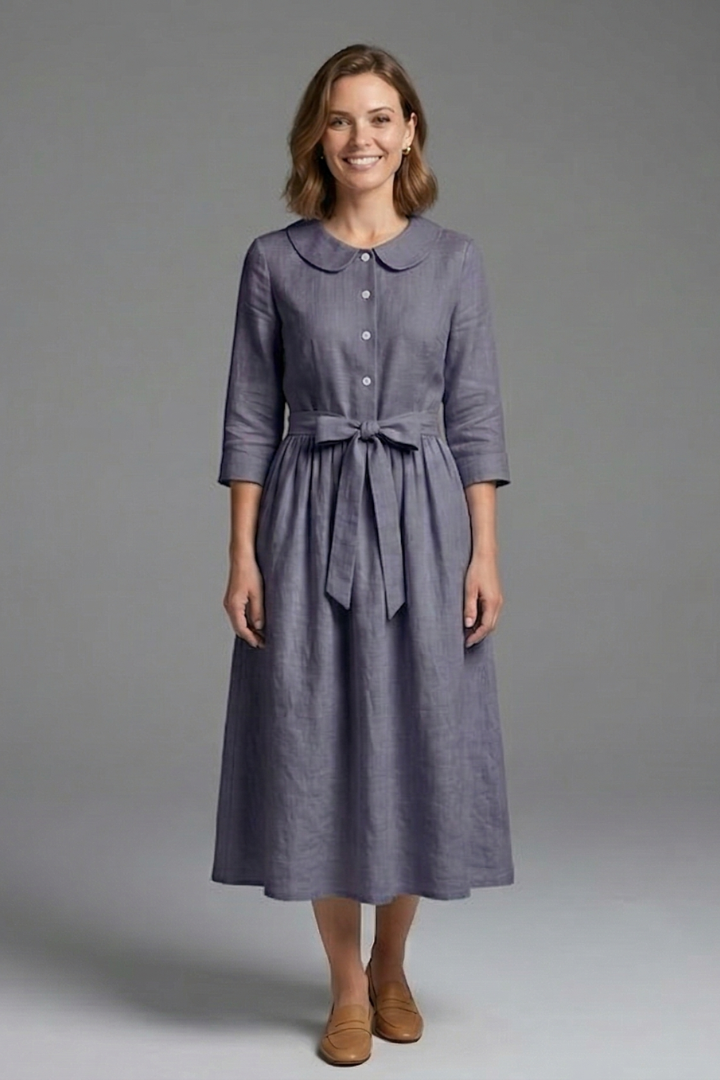 Model in flattering women's V-neck midi dress with waist tie, showcasing comfortable and chic design.