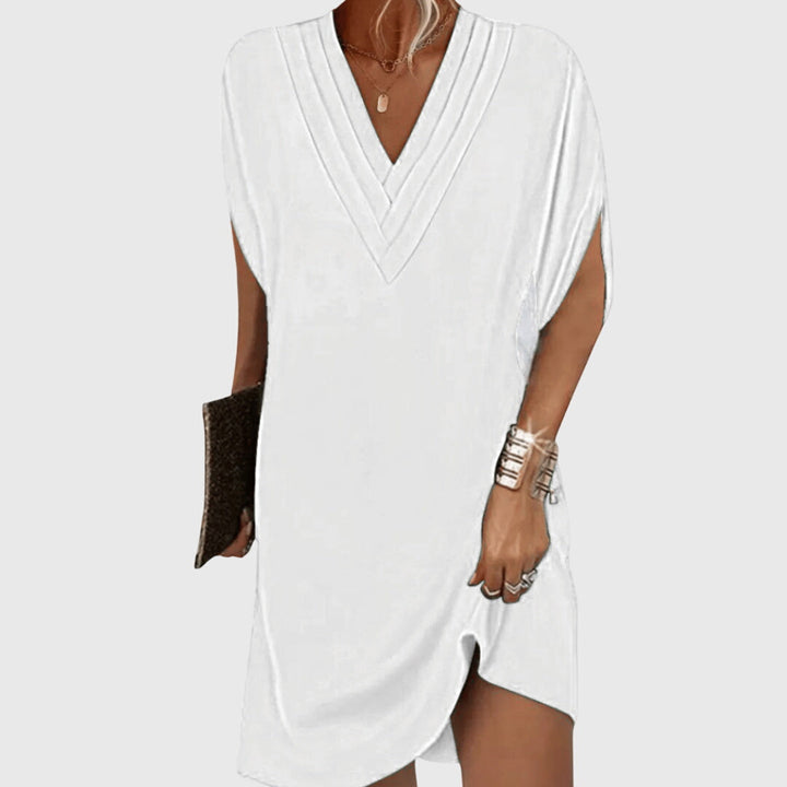 Chic women's V-neck mini dress, short sleeve, relaxed cocoon style, great for casual summer or vacation.