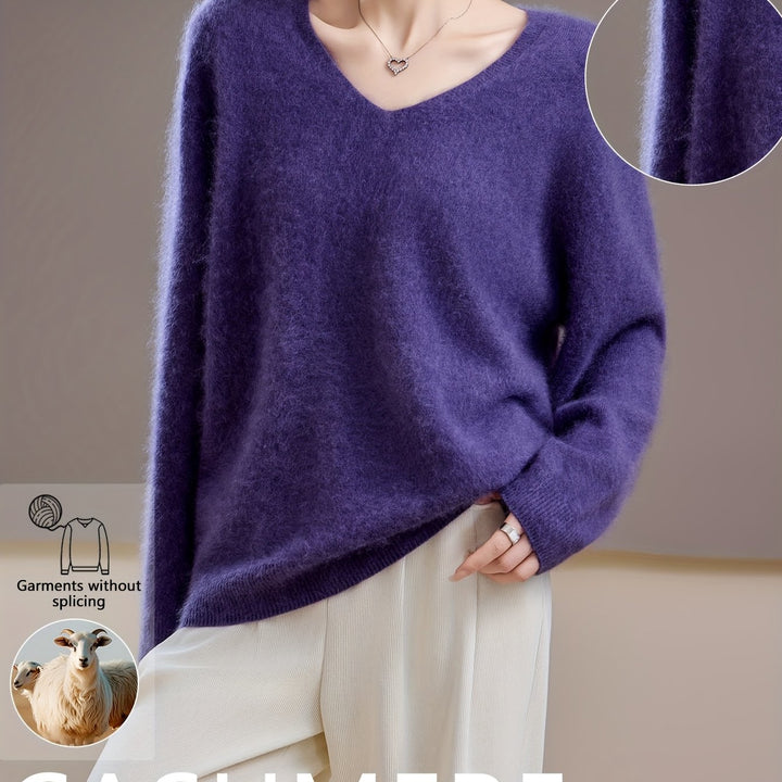Woman wearing an elegant V-neck oversized sweater, styled for chic autumn layering & versatile winter fashion.