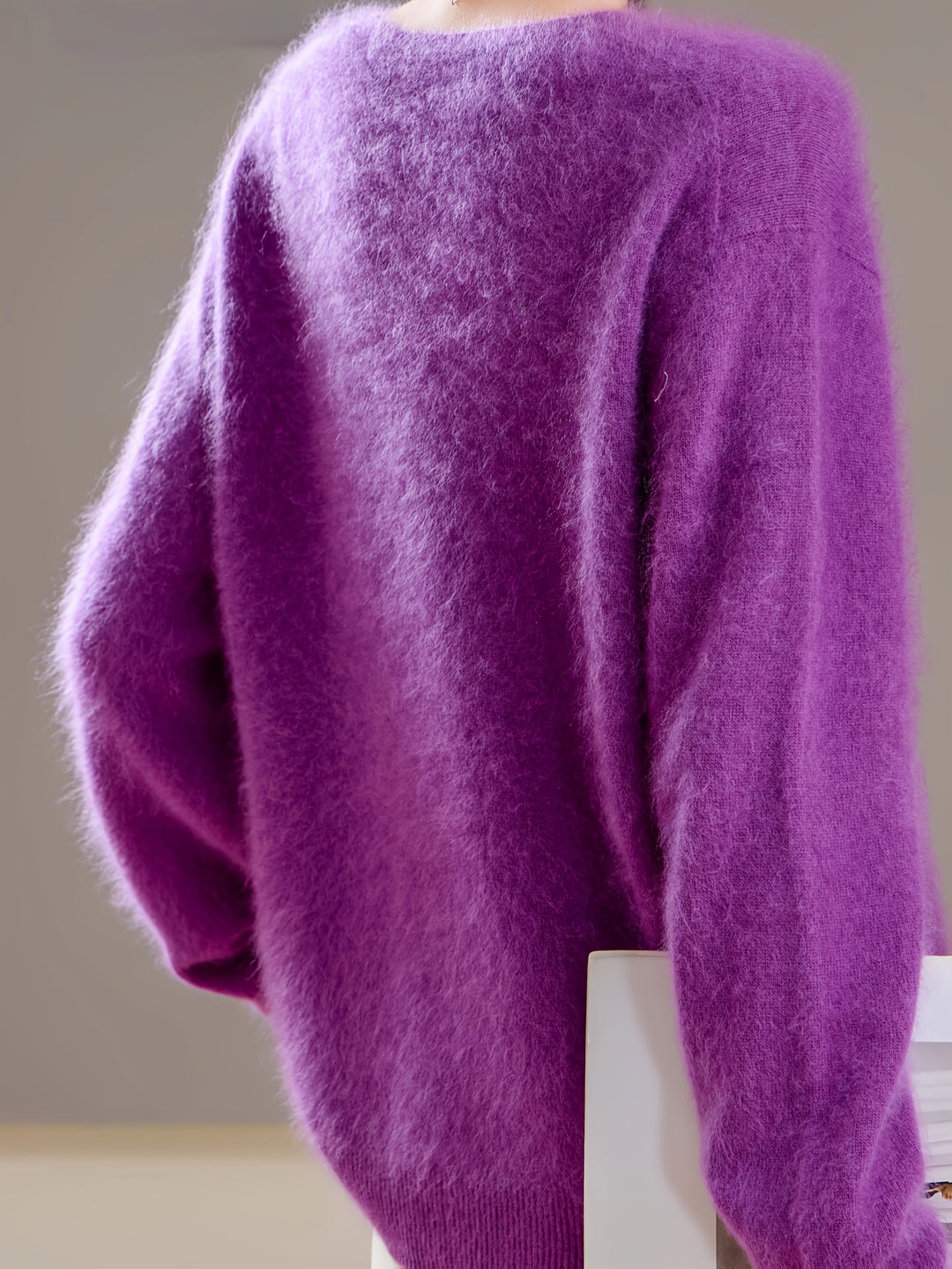 Luxuriously soft V-neck women's knit sweater, oversized for relaxed fit, ideal for elegant autumn layering.