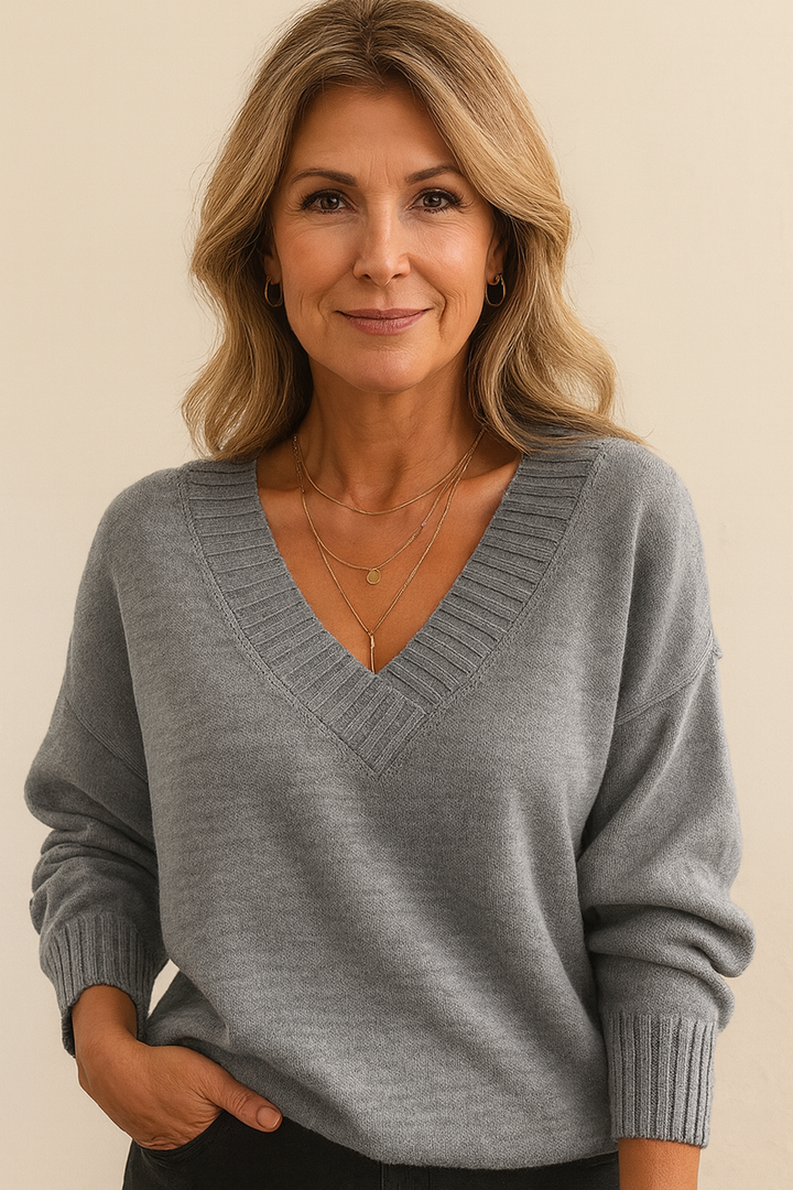 Long sleeve detail of a women's V-neck ribbed sweater, relaxed fit, ideal for cozy fall & winter style.