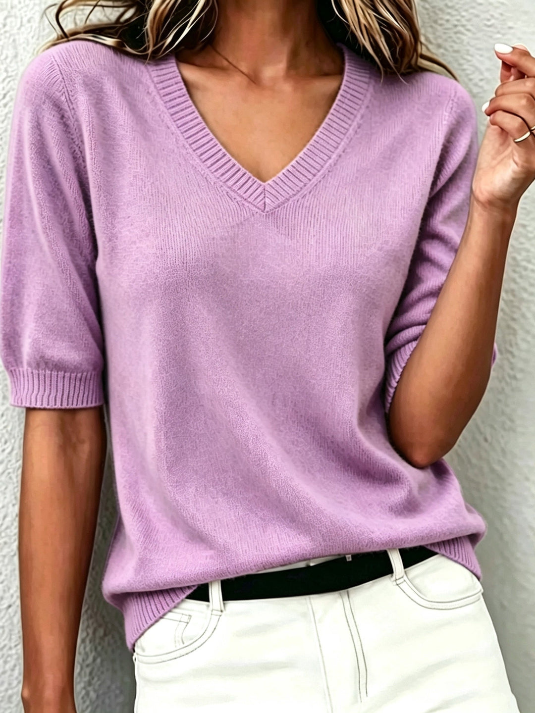 Women's V-neck short-sleeve sweater with ribbed collar. Elegant knit top for versatile fashion.