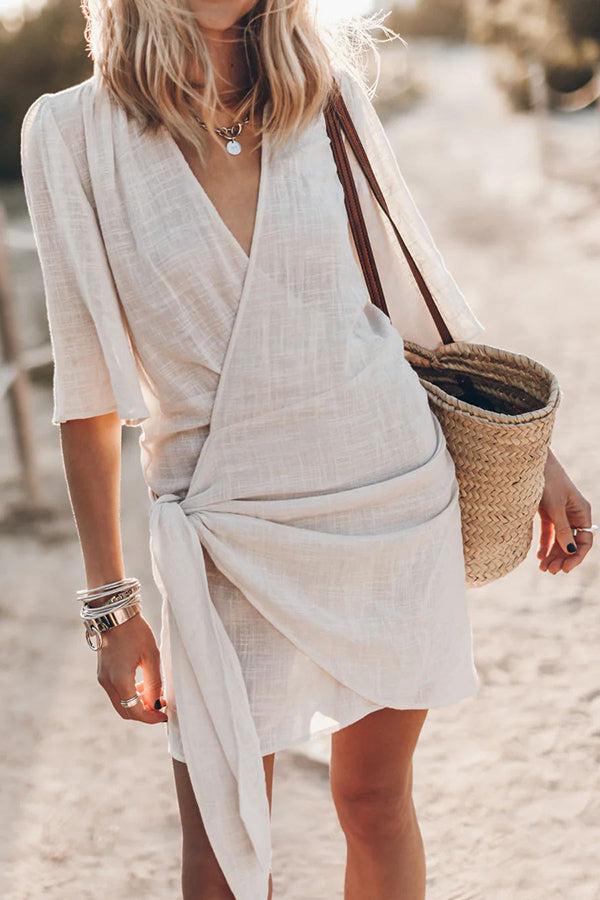 Women's V-neck short sleeve wrap mini dress with tie waist. Perfect for summer casual or beach wear.
