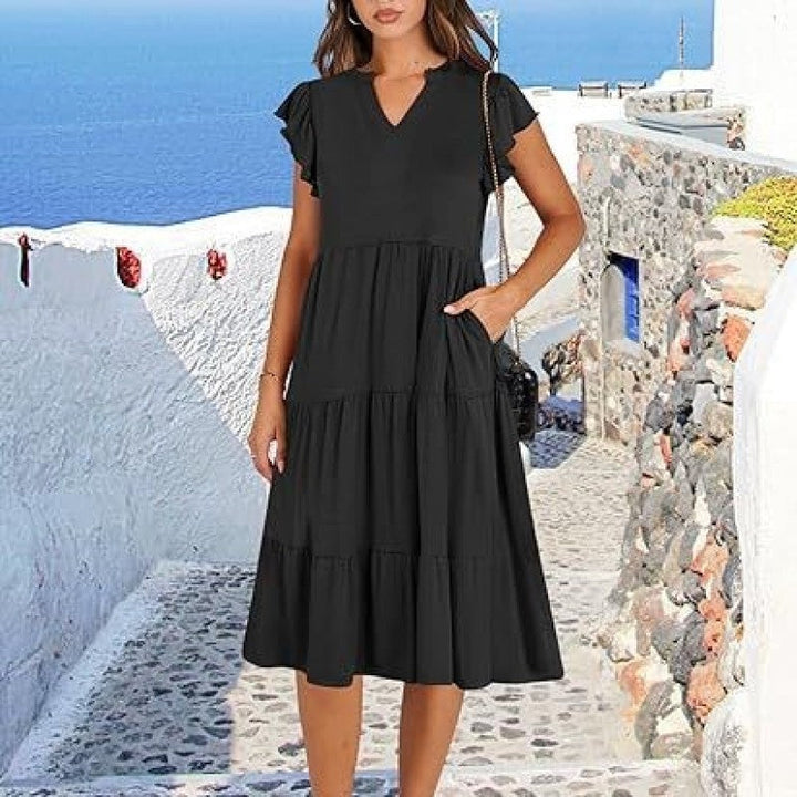 Stylish women's V-neck tiered midi dress showcasing a flowy skirt and delicate flutter sleeves.