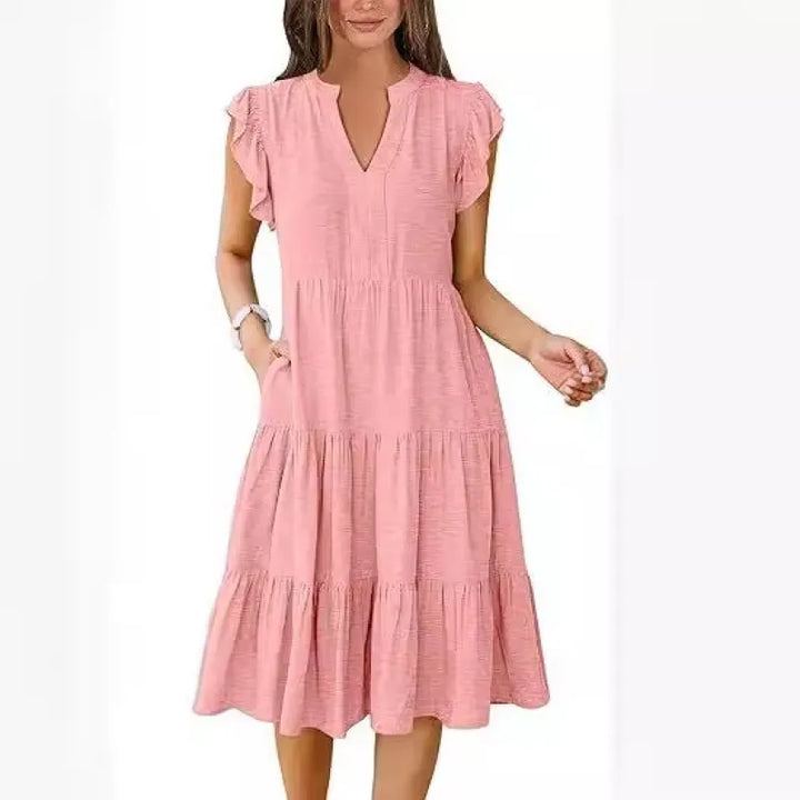 Comfortable women's summer midi dress with V-neck, tiered design, and charming flutter sleeves for vacation.