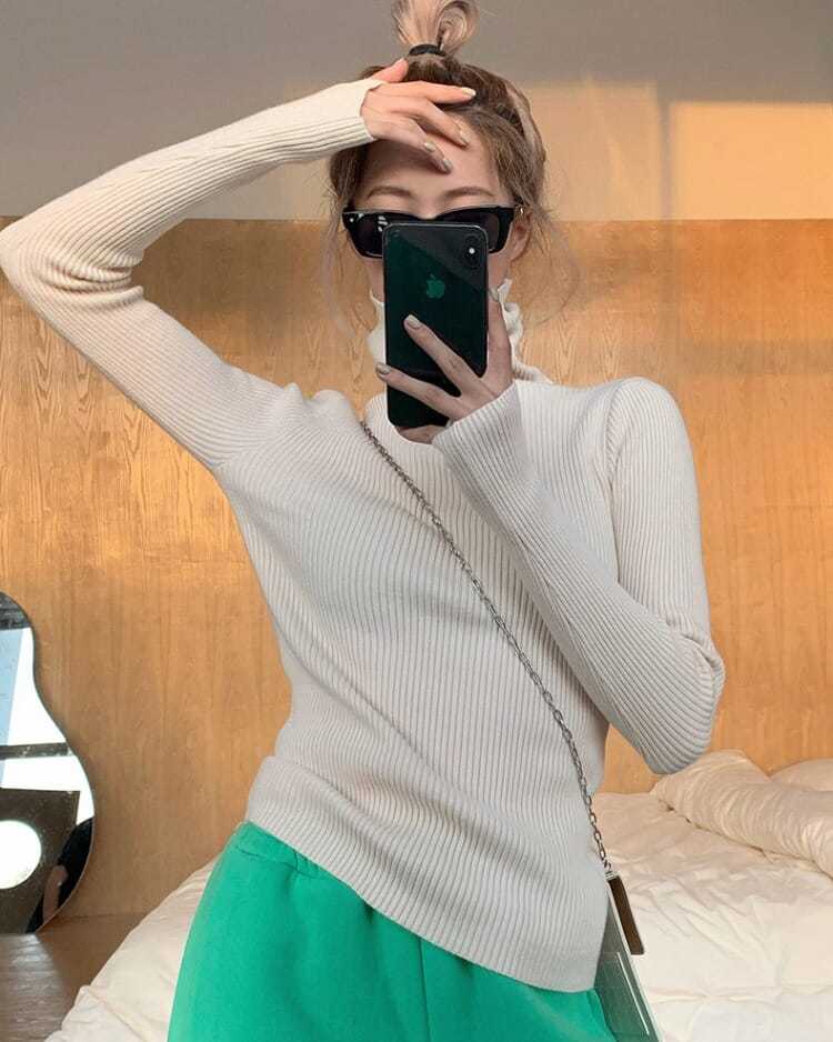 Warm women's long sleeve pullover, a chic turtleneck sweater ideal for winter layering.