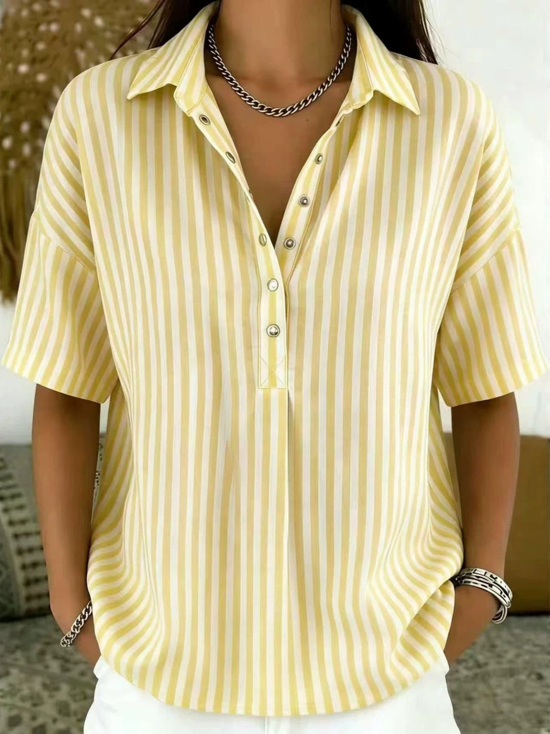 Relaxed fit women's vertical stripe shirt, short sleeve, half-button top. Ideal for casual spring & summer wear.