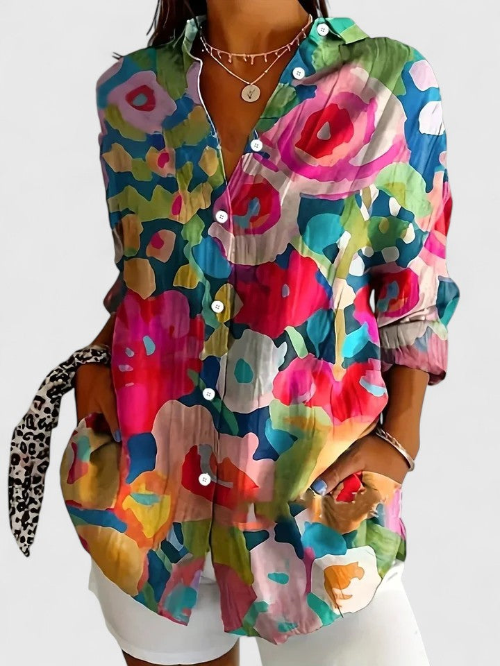 Close-up of a women's vibrant printed blouse, showcasing the unique pattern and soft fabric texture.