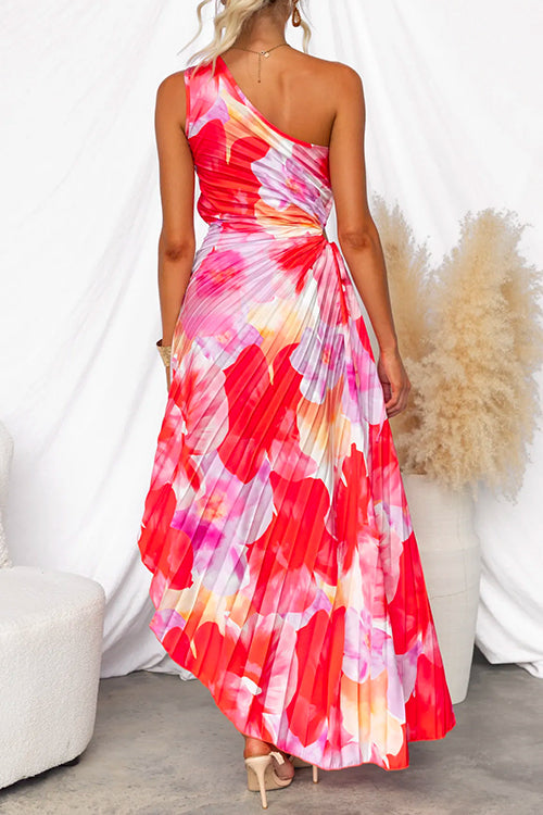 Elegant women's one-shoulder printed dress with vibrant colors and flowing fabric, suitable for evening events.