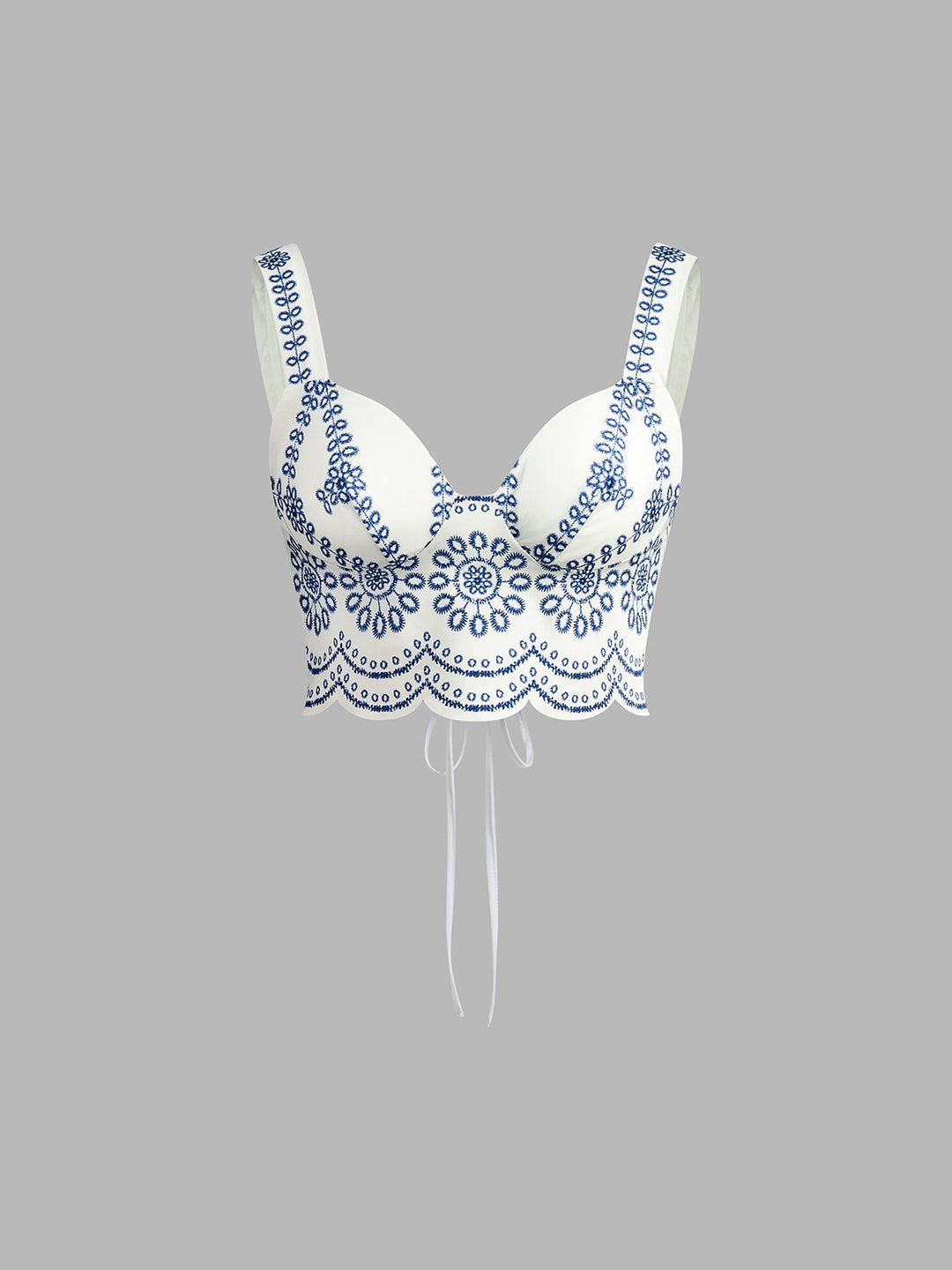 Chic women's printed sleeveless crop top featuring a stylish tie-back detail, paired with a matching summer skirt.