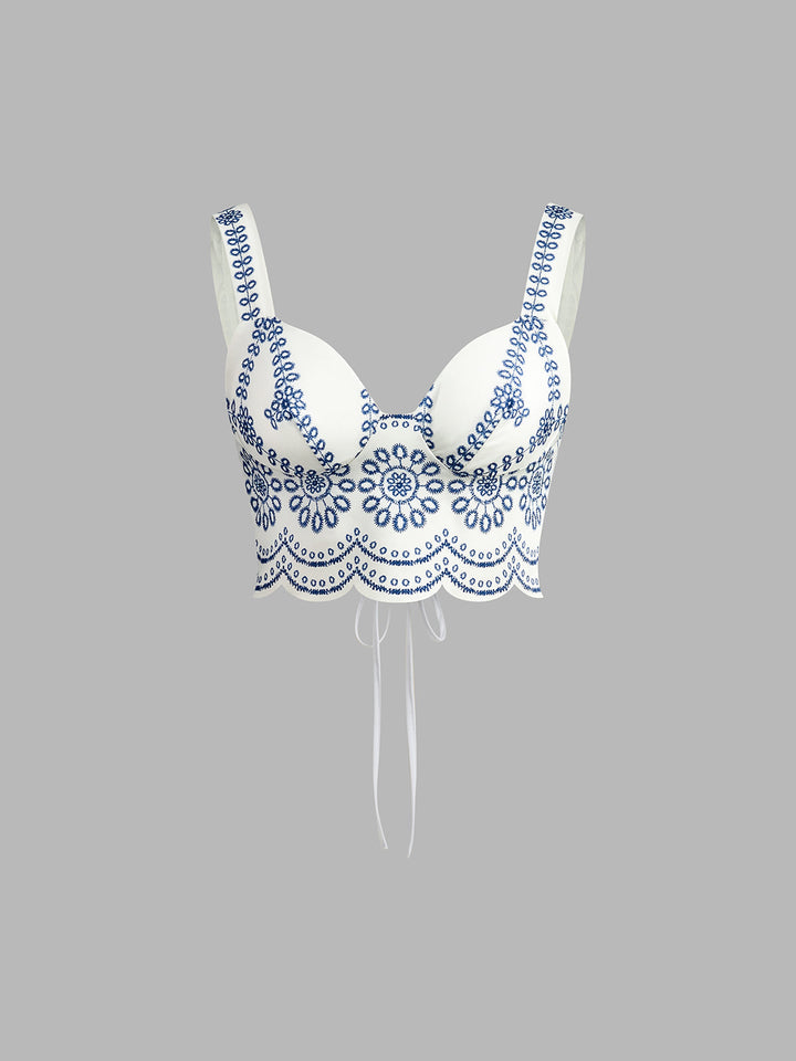 Chic women's printed sleeveless crop top featuring a stylish tie-back detail, paired with a matching summer skirt.