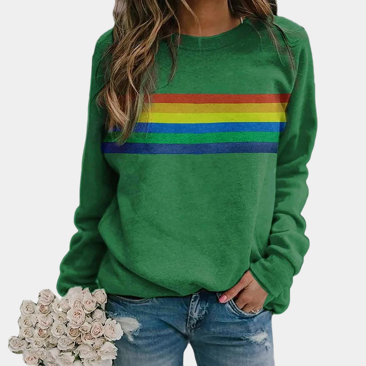 Relaxed fit women's rainbow stripe crewneck sweatshirt, perfect for layering. Features vibrant, colorful stripes.