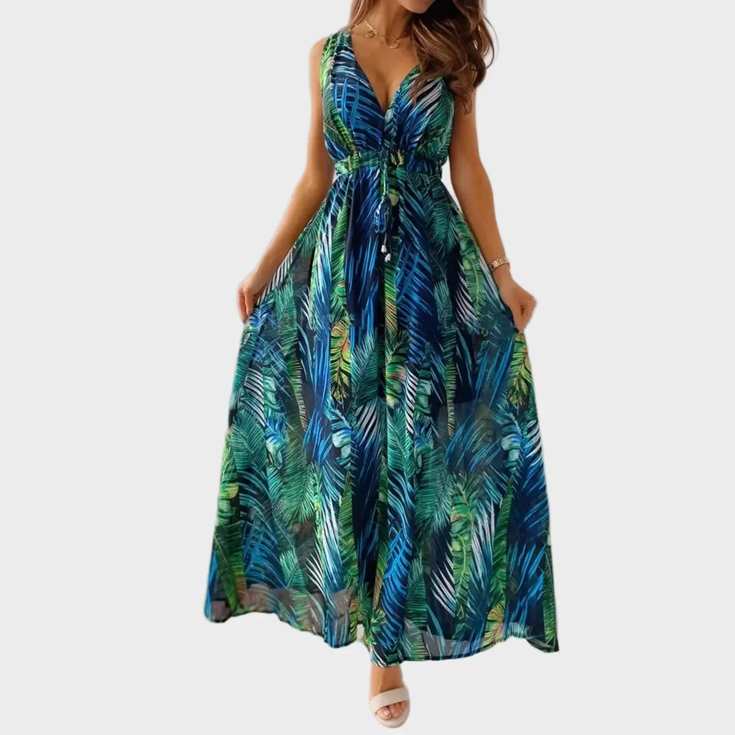 Flowing sleeveless V-neck maxi dress with tropical floral print. Perfect casual summer or vacation wear for women.