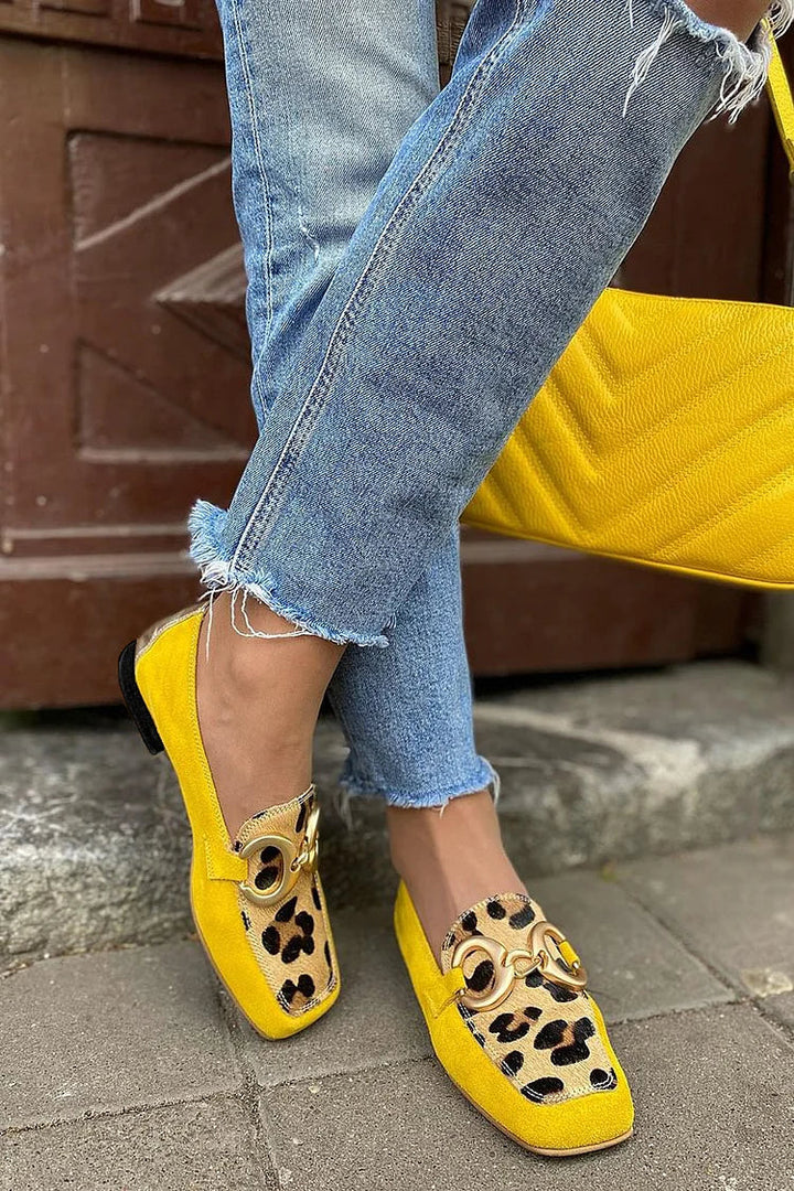 Stylish women's yellow slip-on penny loafers. Chic & comfortable casual footwear, ideal for versatile everyday fashion.