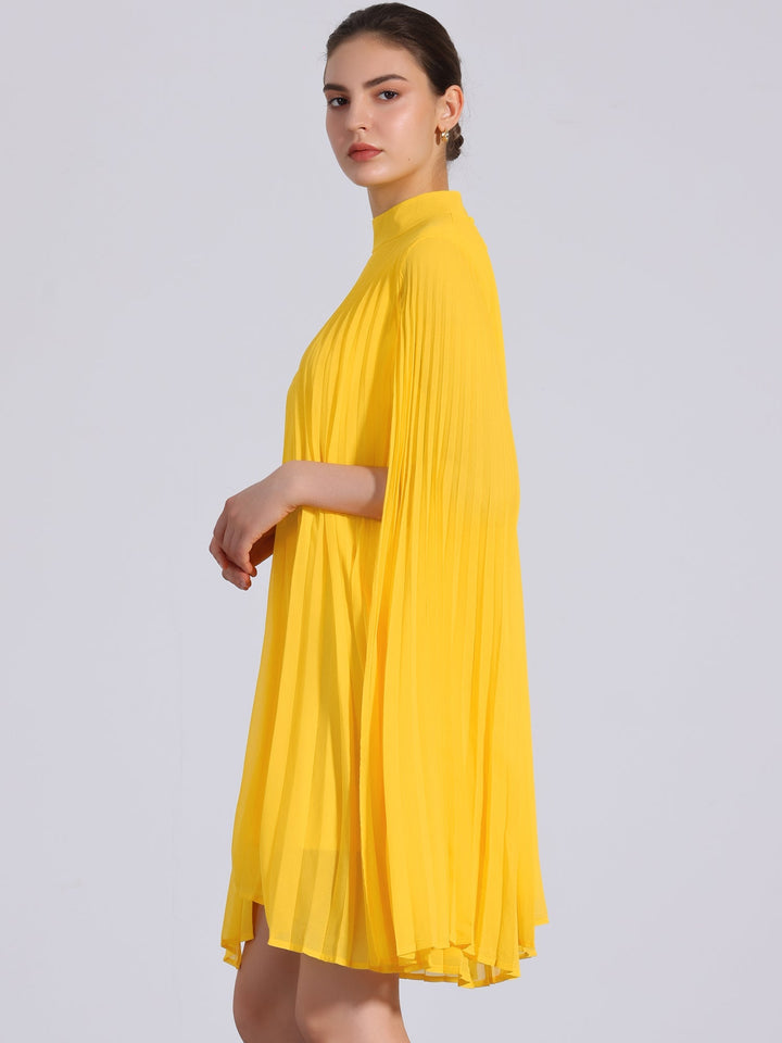 Effortless yellow women's dress: pleated swing style, mock neck, and flowing cape sleeves for a comfortable, chic look.