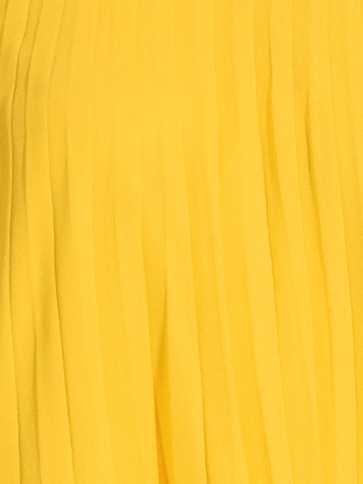 Women's yellow pleated swing dress, featuring a mock neck, cape sleeves, and flowing fabric for an elegant, chic appeal.