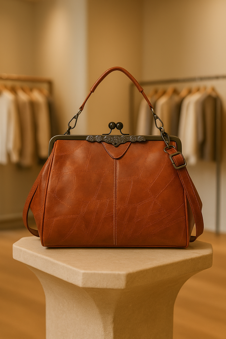 Women's vintage brown leather shoulder bag with adjustable strap, classic elegant style for everyday use.