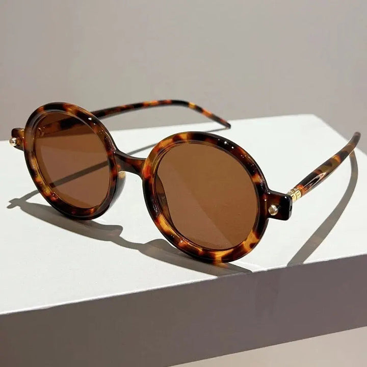 Women's retro circular eyewear, fashionable shades with UV400 sun protection.