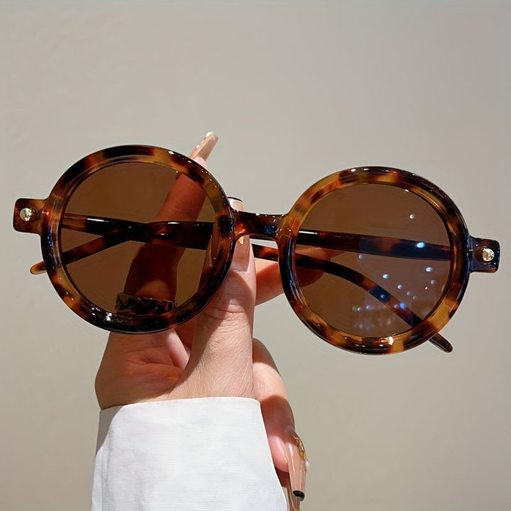 Stylish women's circular sunglasses, retro design with full UV400 protection.