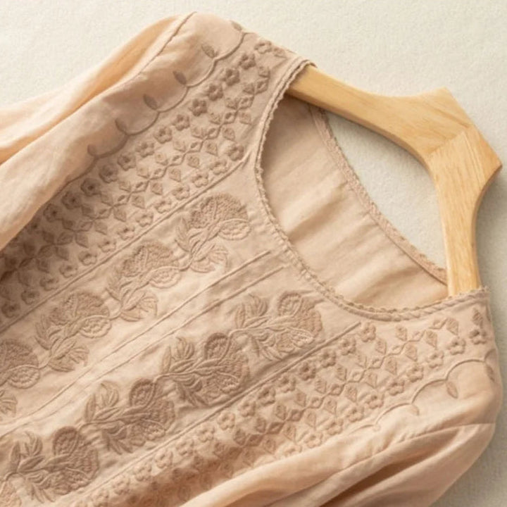 Elegant women's embroidered top, vintage style, featuring puff sleeves & delicate patterns, perfect for chic outfits.