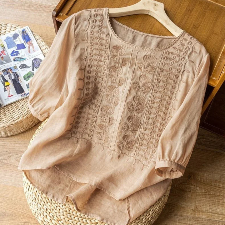 Versatile women's vintage embroidered blouse with three-quarter puff sleeves, great for casual chic or elegant wear.