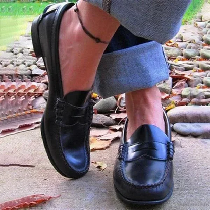 Women's vintage slip-on loafers in black PU leather with a low heel for everyday comfort & classic style.
