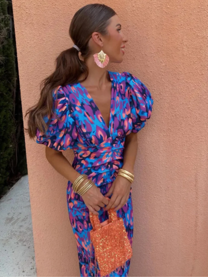 Stylish women's midi dress with sculpted pleats, flattering ruching, and a vibrant, elegant design.