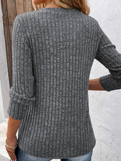 Model wearing a relaxed fit Women's Vivienne ribbed knit Henley top with long sleeves & V-neck, ideal for layering.
