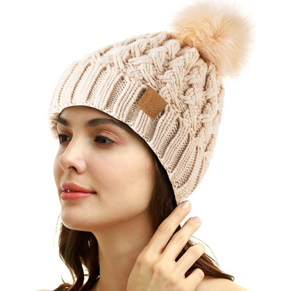 Women's warm winter knit hat, cable pattern & fleece-lined, with a cute pom-pom.