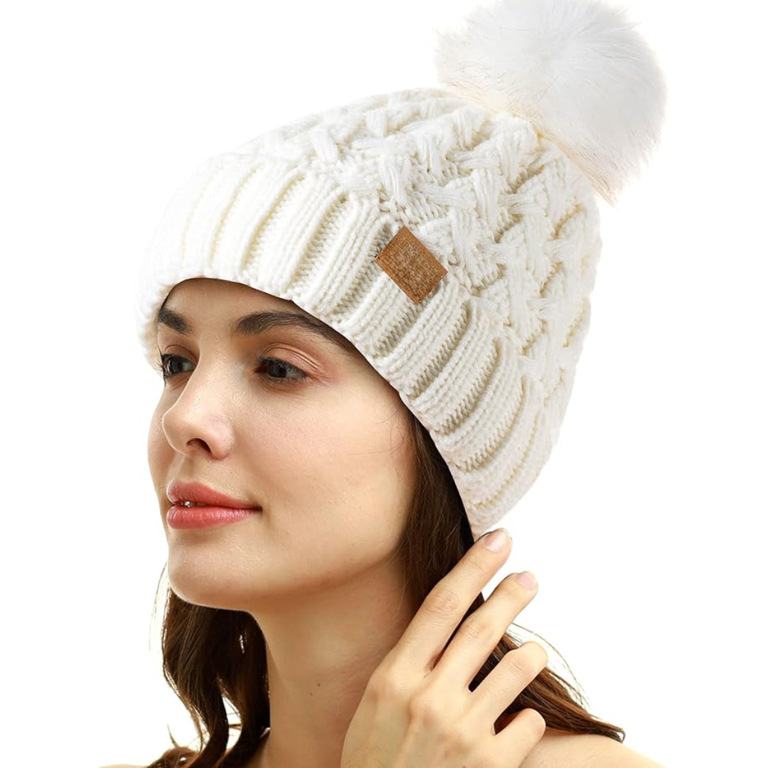 Cozy women's fleece-lined cable knit hat, perfect for winter, featuring a stylish pom-pom.