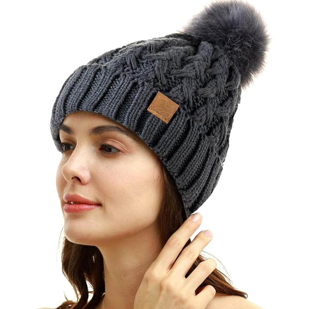 Textured women's cable knit beanie, fleece-lined for comfort, finished with a soft pom-pom.