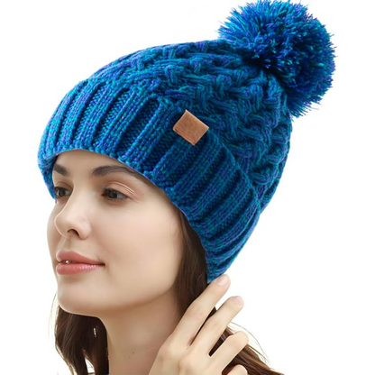 Keep warm with this women's cable knit winter hat, featuring a cozy fleece lining & pom-pom.