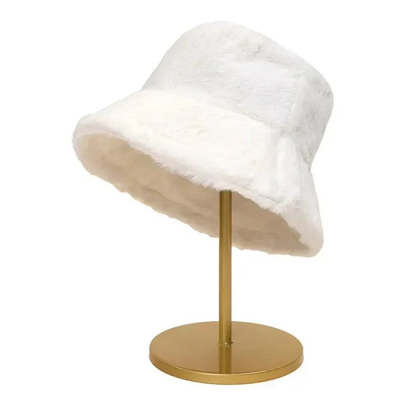 Fashionable autumn/winter faux rabbit fur bucket hat for women. Plush, warm, and chic accessory.