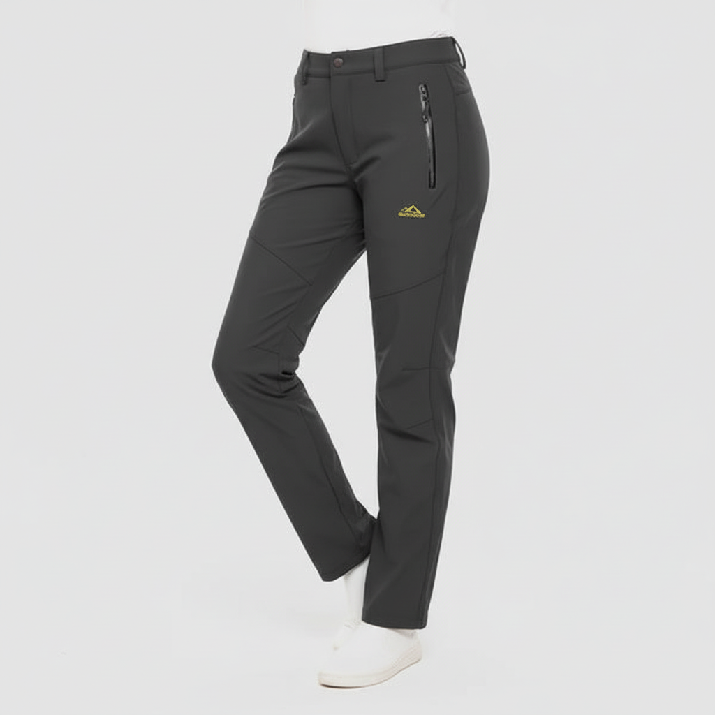 Woman hiking in comfortable Lydia waterproof insulated outdoor pants. Ideal activewear for cold weather exploration.