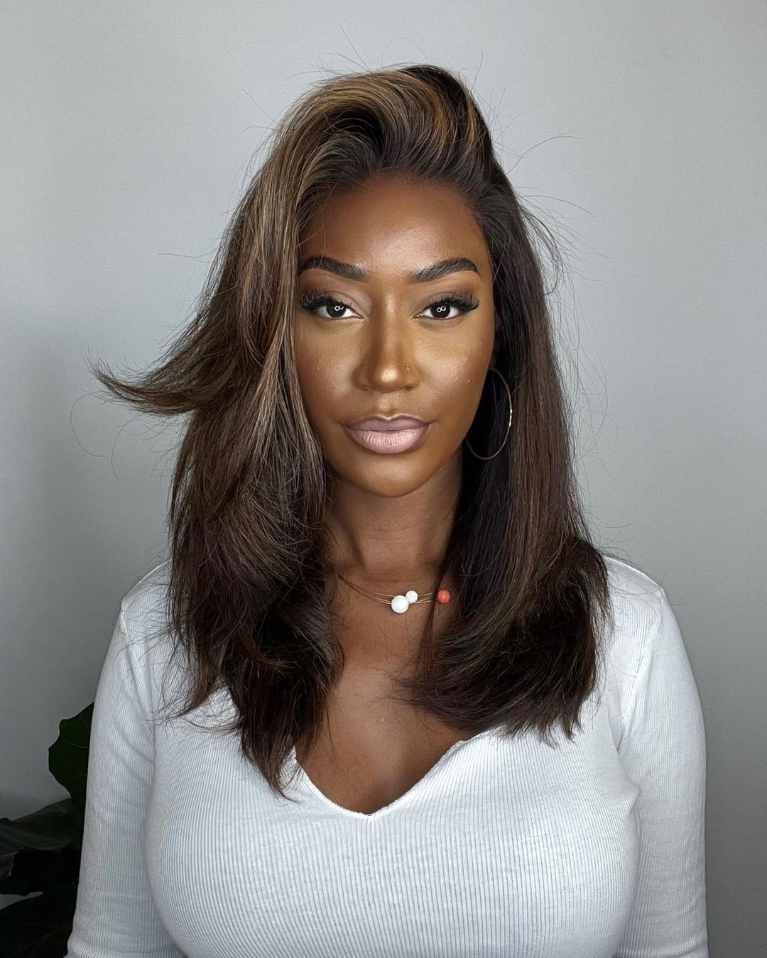 Wavy human hair lace front wig for women, dark brown with blonde highlights, premium quality.