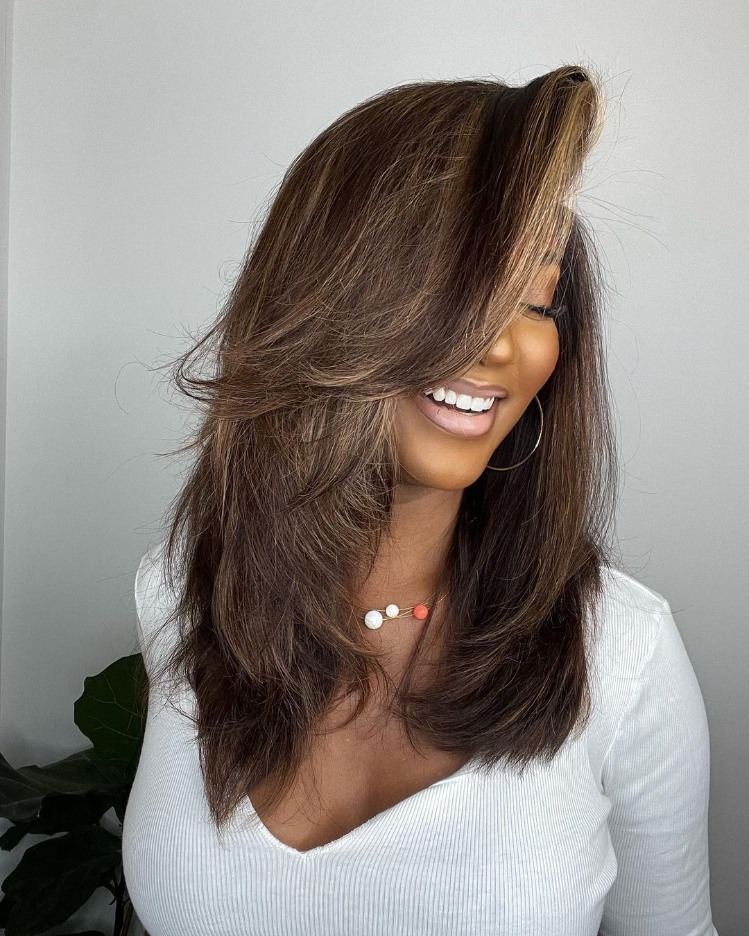 Elegant women's wavy human hair lace front wig, dark brown base with blonde highlights for a chic look.