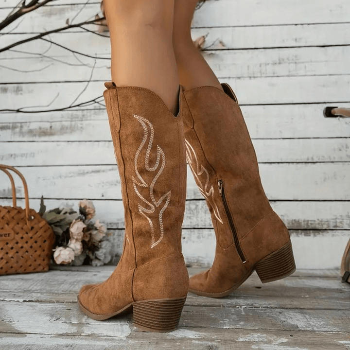 Stylish women's cowboy boots. Features an easy on/off side zipper, classic western embroidery, and a pointed toe.