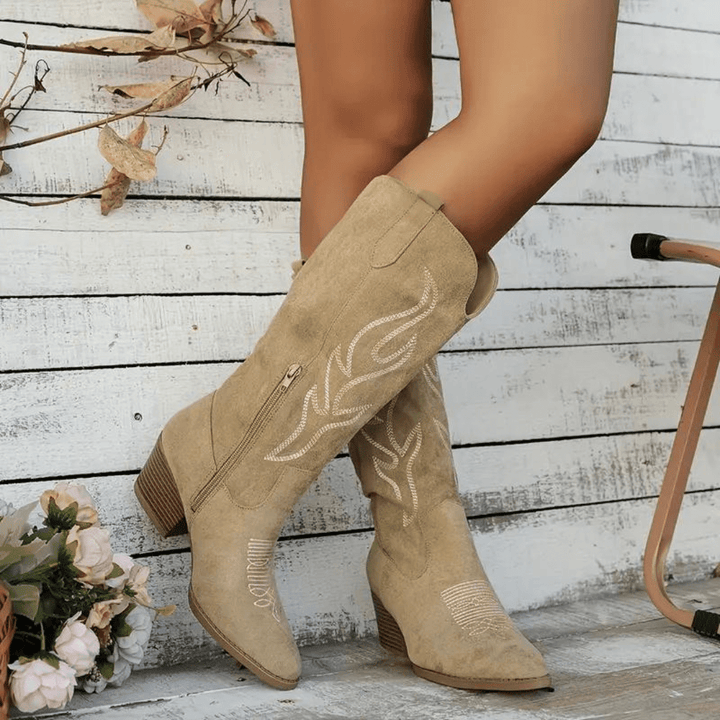 Fashionable women's cowboy boots in western style with intricate embroidery, side zipper, pointed toe, block heel.