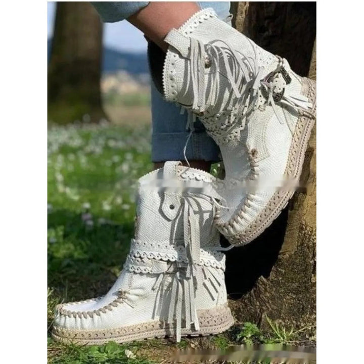 Stylish women's fringed ankle boots for a boho western look. Round toe, flat sole, perfect festival wear.