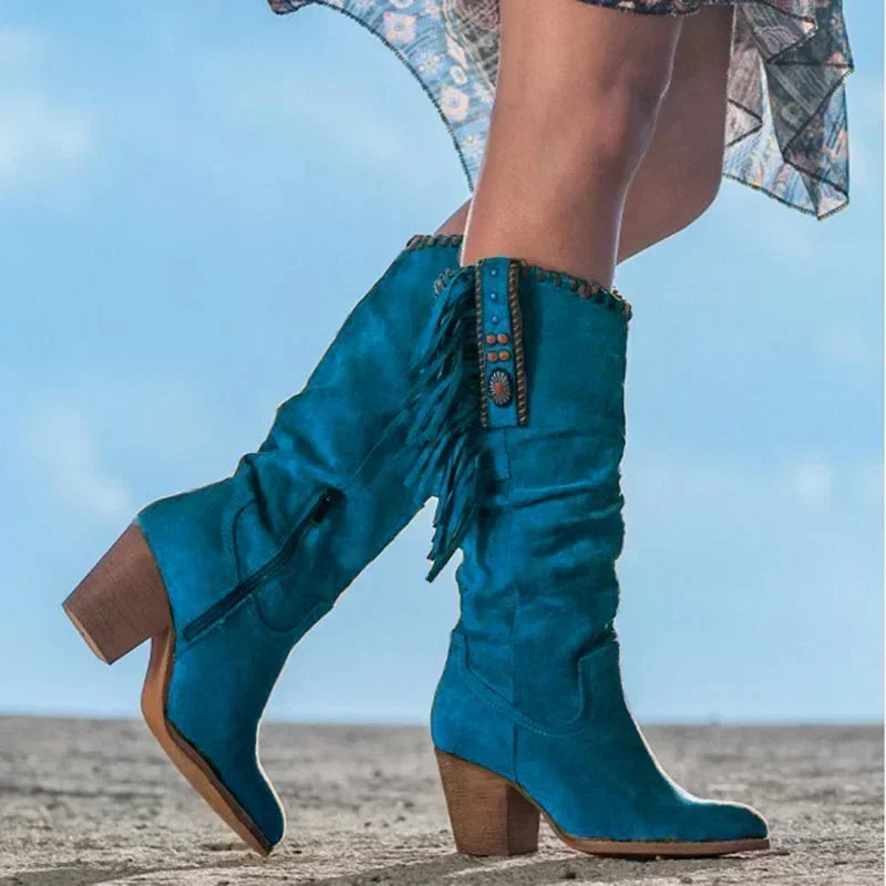 Boho chic women's mid-calf slouch boots featuring dynamic fringe and eye-catching turquoise stud accents.