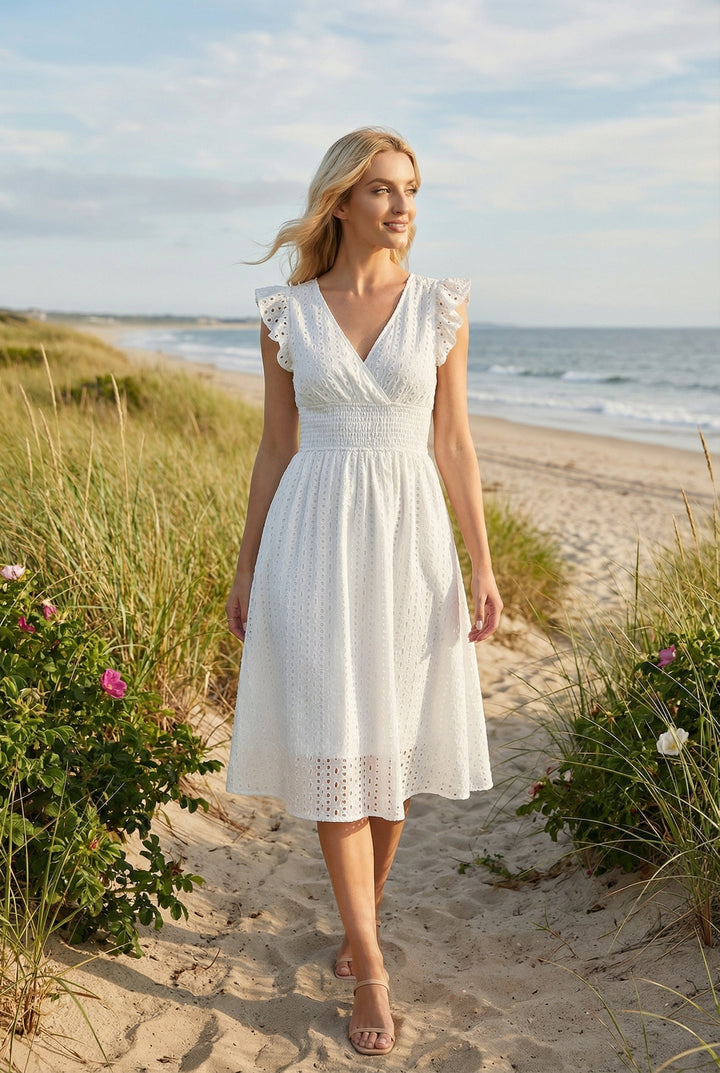 Side profile: Comfortable women's flared eyelet midi dress with ruffled sleeves, ideal for warm weather summer style.