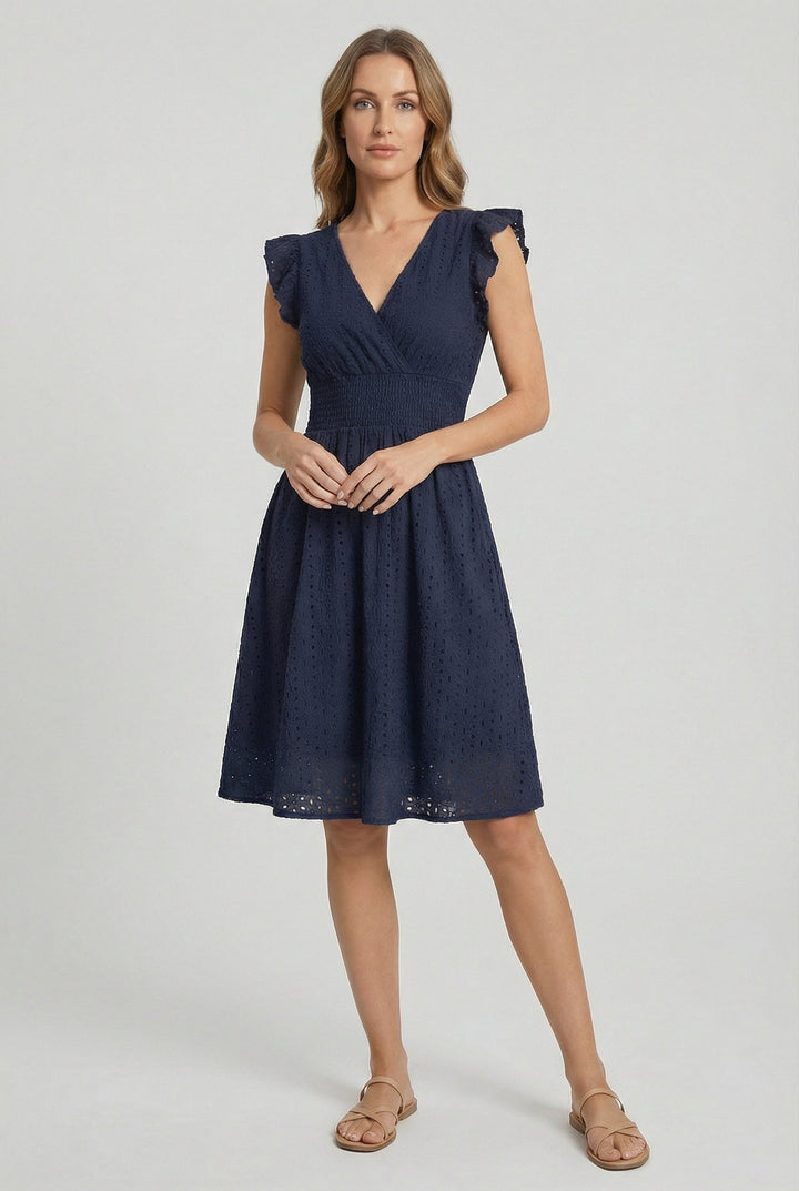 Detailed view of ruffled sleeves on a women's comfortable eyelet midi dress with smocked waist. Essential summer fashion.